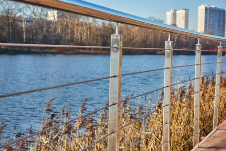 Promenade with railings and wooden flooring in the city. Photo composition.の写真素材