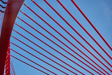Abstract architectural features, steel beam with cables on sky background.の写真素材