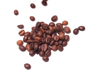 Pile of coffee beans isolated on white background.の写真素材