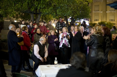 Spain, Cordoba - 3 January 2010: A group of neighbors are singing together in the front of their apartment building during the New Year holidays.のeditorial素材