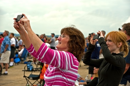Portsmouth, USA - August 14, 2011: People taking photos of planes during an air show.のeditorial素材
