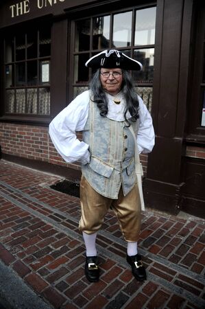 Gentleman dressed in colonial clothes poses near historic tavern in Boston downtown.のeditorial素材