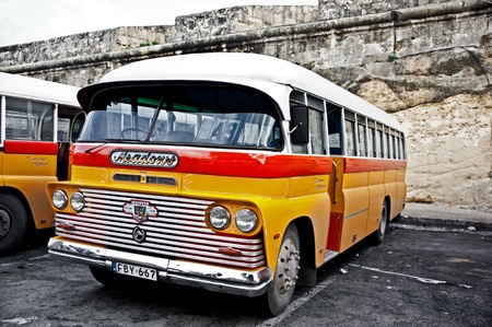 a classic yellow bus at the main bus station in Valetta. のeditorial素材