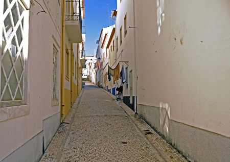 A back street in the fishing village Nazareの写真素材
