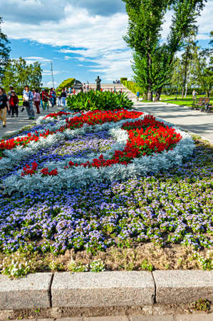 Irkutsk, Russia - August 29, 2016 - People are walking down in a public park decorated with colorful flowerbeds.のeditorial素材