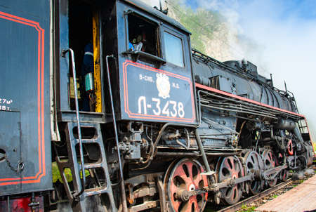 Irkutsk, Russia - August 30, 2016: a retro steam train takes tourists for a journey by the Circum-Baikal Railway, a historic rail road.のeditorial素材