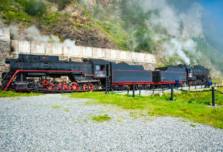 Irkutsk, Russia - August 30, 2016: a retro steam train takes tourists for a journey by the Circum-Baikal Railway, a historic rail road. The Circum-Baikal is one of the picturesque sights of the area aのeditorial素材
