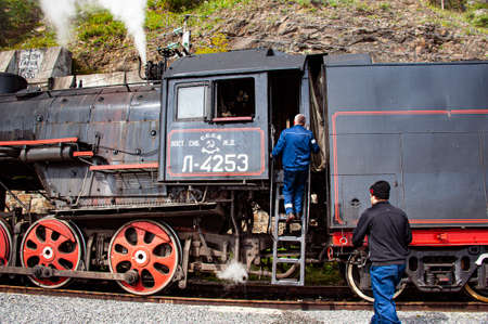 Irkutsk, Russia - August 30, 2016: a retro steam train takes tourists for a journey by the Circum-Baikal Railway, a historic rail road. The Circum-Baikal is one of the picturesque sights of the area aのeditorial素材