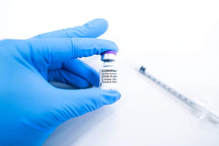 Pfizer Biontech Cominaty COVID-19 RNA Vaccine vial and syringe for prevention novel coronavirus disease 2019 on white background. Medicine infectious or immunization concept.のeditorial素材