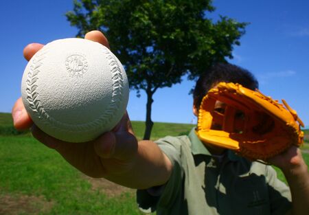 A shy japanese player with a ball on his handsの写真素材