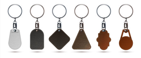 Key holder. Realistic keychain ring with faux calf leather tags. Isolated 3D premium fobs mockup. Steel breloques and labels from natural materials. Vector keyrings set for brandingのイラスト素材