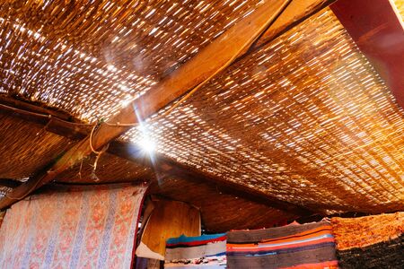 Sunlight shines through the straw roof on the stop in the desert near Dahab, Egypt. Sun flares.の写真素材