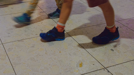 A vibrant urban scene vividly depicting individuals in stylish sneakers leisurely walking along a...