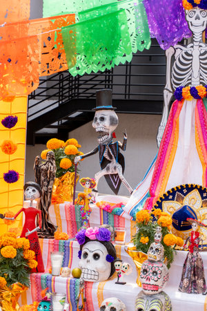 A festive arrangement of skeletons and skulls, including a man in a top hat, is on display for Dia...
