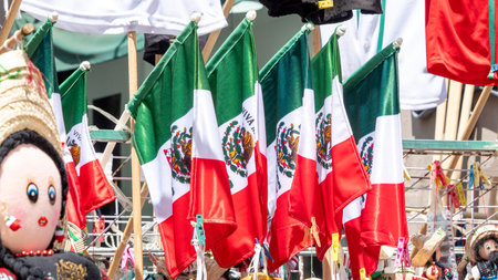 A group of flags with the word Mexico on them. The flags are hanging on a rack. The flags are red, white, and green. Decoration to celebrate Independence Day in Mexico, zocaloの写真素材