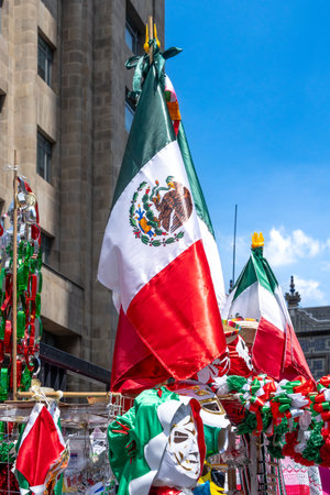 A flag with the word Mexico on it is hanging from a pole. The flag is red, white, and green....