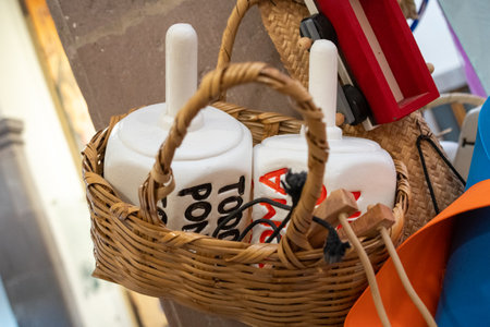 A basket of items with a white container that says ToP on it. The basket is made of woven material....