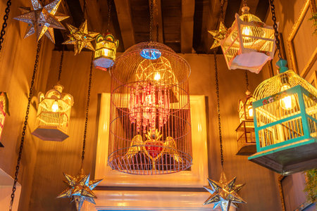 A room with many bird cages hanging from the ceiling. The cages are of different sizes and colors. Historic center of Queretaro, colonial architecture, decorations for the celebration of Mexico's Independence Day.の写真素材