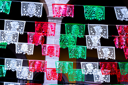 A vibrant display of paper flags with faces on them, arranged in a way that they appear to be...