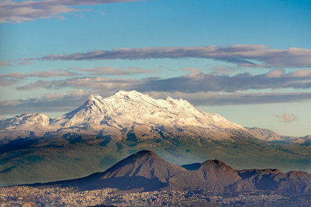 A beautiful mountain range with snow-covered peaks, creating a serene and peaceful atmosphere. In the background. Panoramic view of Mexico City, snow-covered volcanoes Popocatepetl and Iztaccihuatlの写真素材