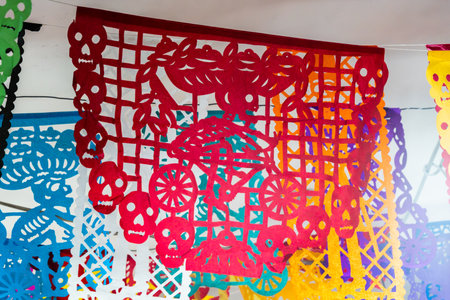 A vibrant display of paper lanterns, each with a unique design. Mexican Day of the Dead tradition, offerings, food, colors, decorations, and papel picado, La Catrina.の写真素材