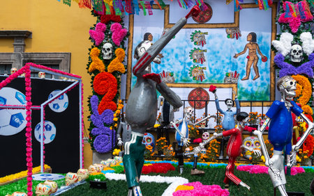 A group of skeletons are playing a game of soccer. The skeletons are dressed in colorful clothing. Mexican Day of the Dead tradition, offerings, food, colors, decorations, and papel picado, La Catrina.の写真素材