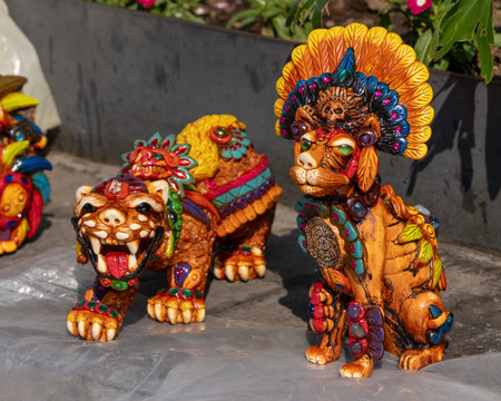 Two animal figurines, one of which is a tiger and the other a bear, are placed close to each other.の写真素材