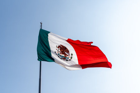 A red, white, and green flag with a blue sky in the background.の写真素材