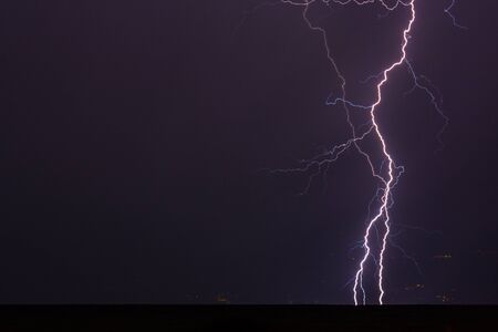 A thunderstorm with excessive lightning at Lake Garda in summerの写真素材