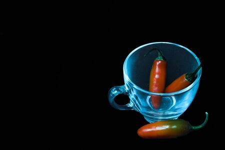 Chillies with a glass cupの写真素材