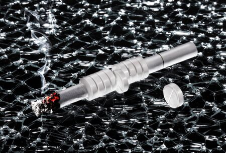 Cigarette and pills on the broken glassの写真素材