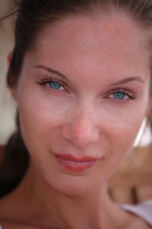 Face of beautiful young woman with frecklesの写真素材