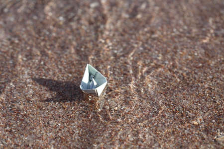 Paper boat in the riverの写真素材