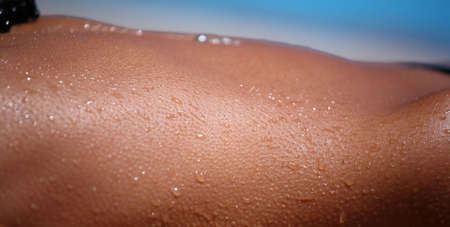 Wet woman body on the sunの写真素材