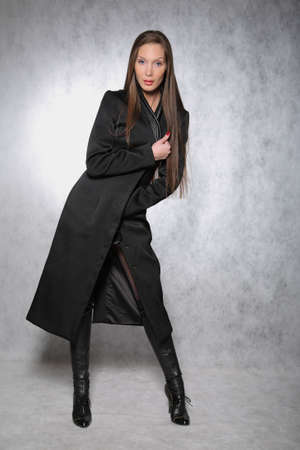 Woman in a coat posingの写真素材