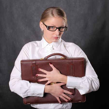 Woman hugging leather briefcaseの写真素材