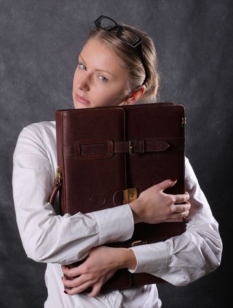 Woman hugging leather briefcaseの写真素材