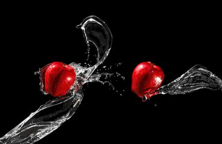 Two red apples in water streamの写真素材