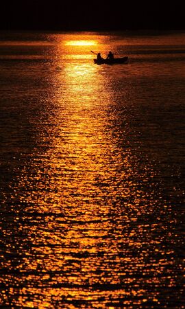 Sun reflection in the water during the sunsetの写真素材
