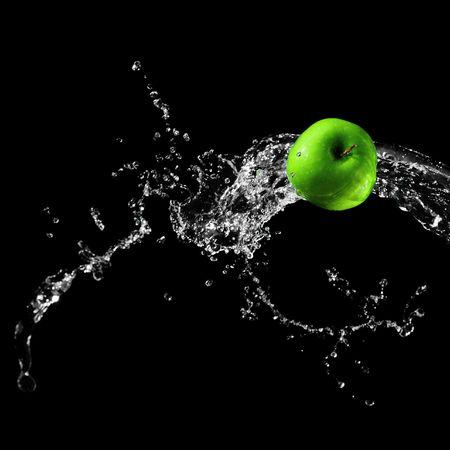 Green apple in water streamの写真素材