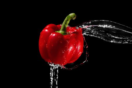 Red pepper in water streamの写真素材
