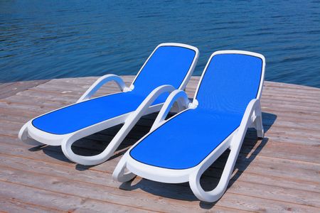 Two chaise longues on the deck pierの写真素材