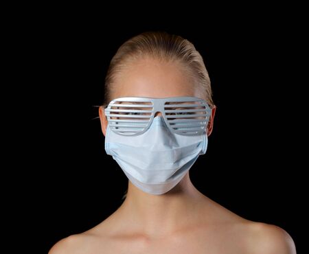 Young woman in mask and glassesの写真素材