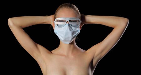 Young woman in glasses and protective maskの写真素材