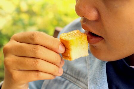 man eating bake bread, butter - a sweet dessert.の写真素材