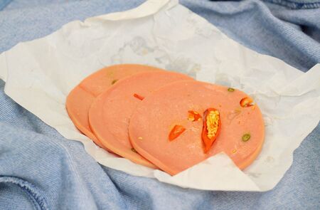 Spicy Bologna sausage on a background - food