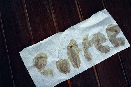 paper word coffee on a wooden table