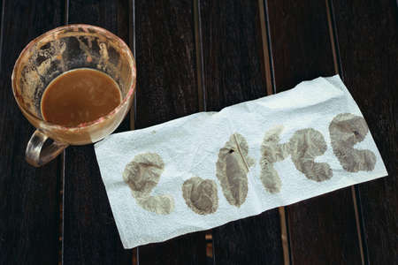 hot coffee with paper on a wooden table.の写真素材