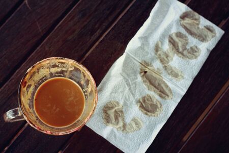 hot coffee with paper on a wooden table.の写真素材