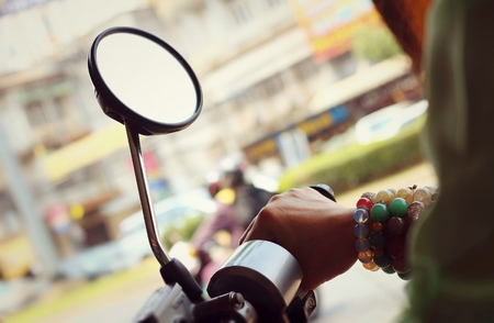 Women wear bracelets handle Motorcycles in parking.の写真素材